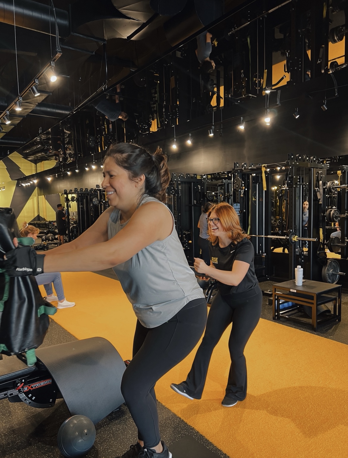 Personal trainer coaching a client at Rise