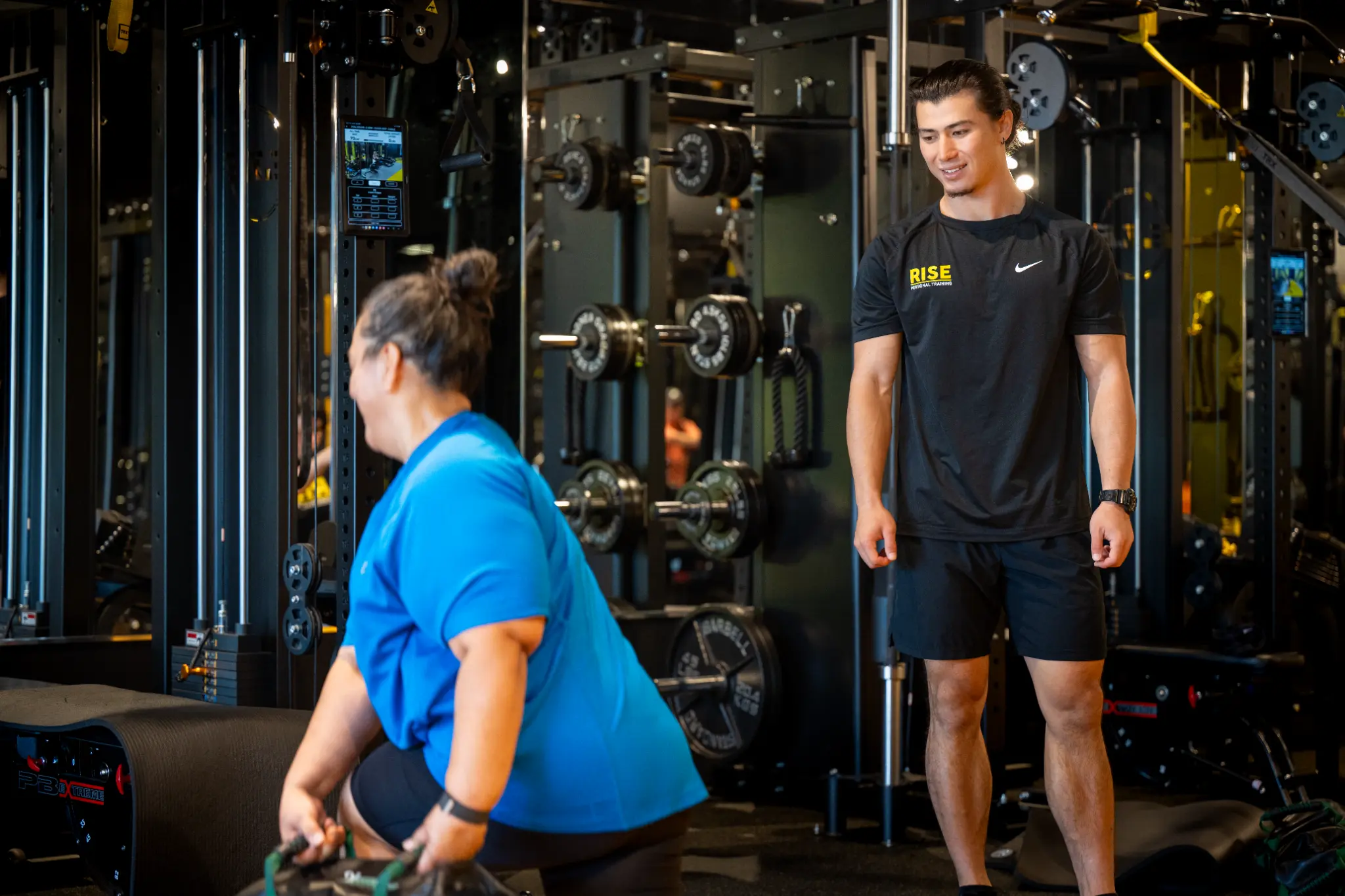 Rise Personal Training coach helping member with personalized workout